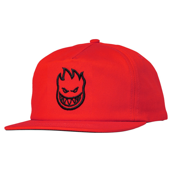 A SPITFIRE Bighead snapback hat in red with a face on it.