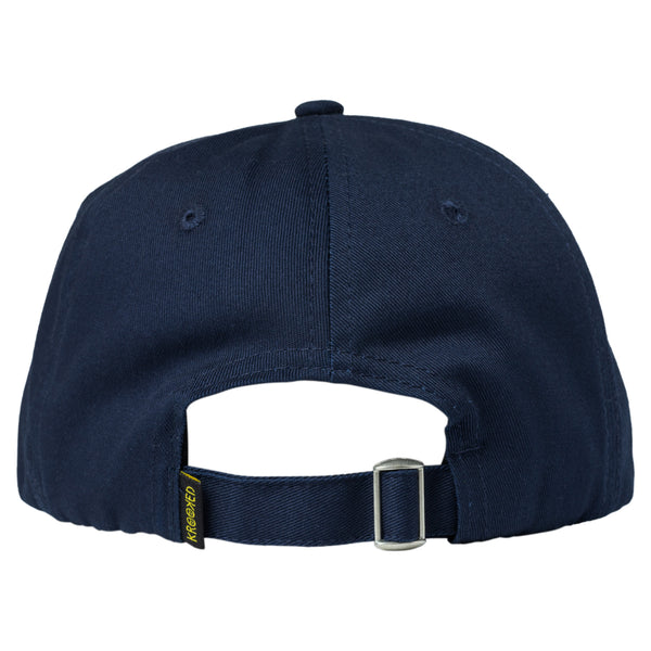 The KROOKED MOONSMILE SCRIPT STRAPBACK NAVY / WHITE has a buckle on the back.