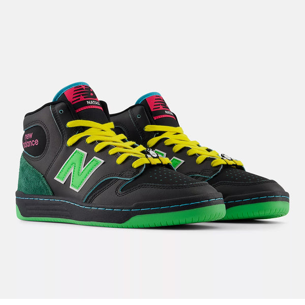 Black high-top sneakers with green accents, neon yellow laces, and a prominent "N" logo on the sides. These NB NUMERIC NB NUMERIC X NATAS KAUPAS 480 HIGH BLACK / LIME GREEN shoes also feature a red tongue label and a green outsole, blending modern flair with hightop heritage styles.