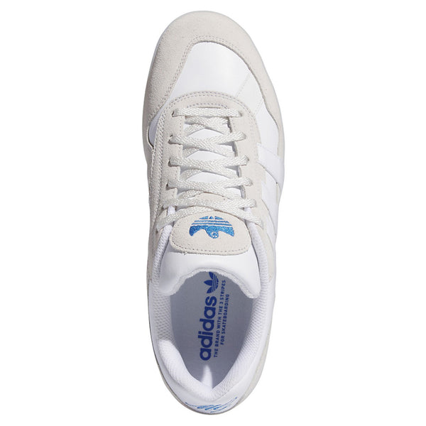 The top view of the white shoe with suede and leather paneling and a blue gonz logo on the tongue.