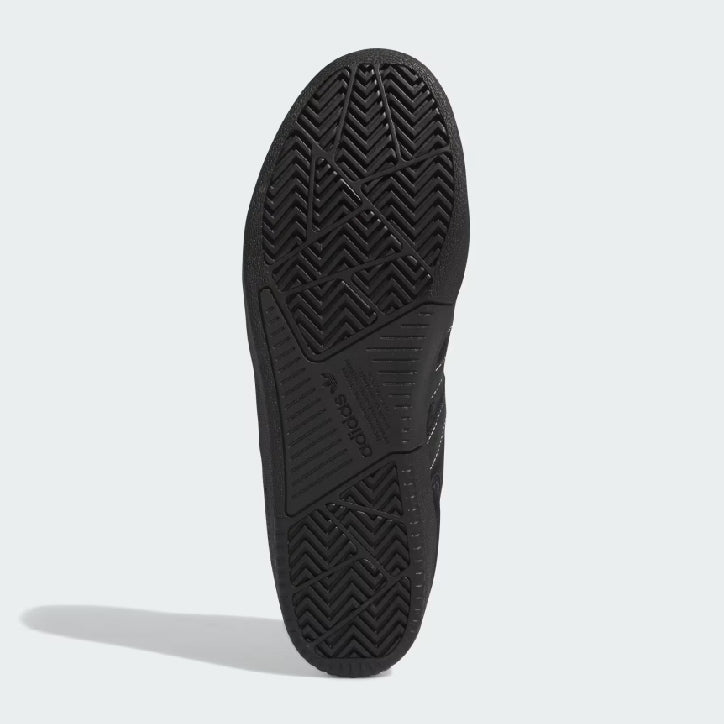 A black ADIDAS TYSHAWN LOW BLACK / WHITE / GOLD METALLIC sole displaying intricate tread patterns and the brand name embossed in the center.