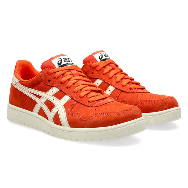 A pair of the orange shoes with matching orange laces and the asics logo on the tongue.