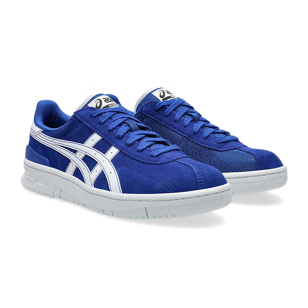 ASICS VIC NBD CLAY sneakers in Prussian blue with white details, featuring a wavy stripe design on the side.