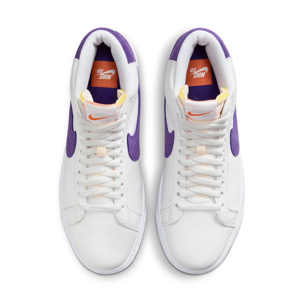 The top view of a white pair of shoes with purple accents that has the nike logo in the insole and the tongue.