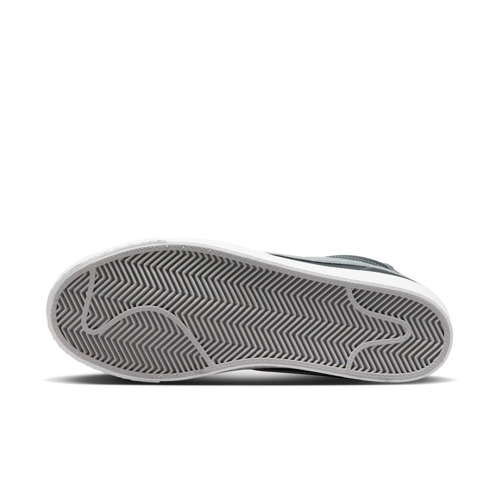 A close up of a Nike SB Blazer Mid X Mason Silva Blacked Blue / Wolf Grey shoe on a white background.
