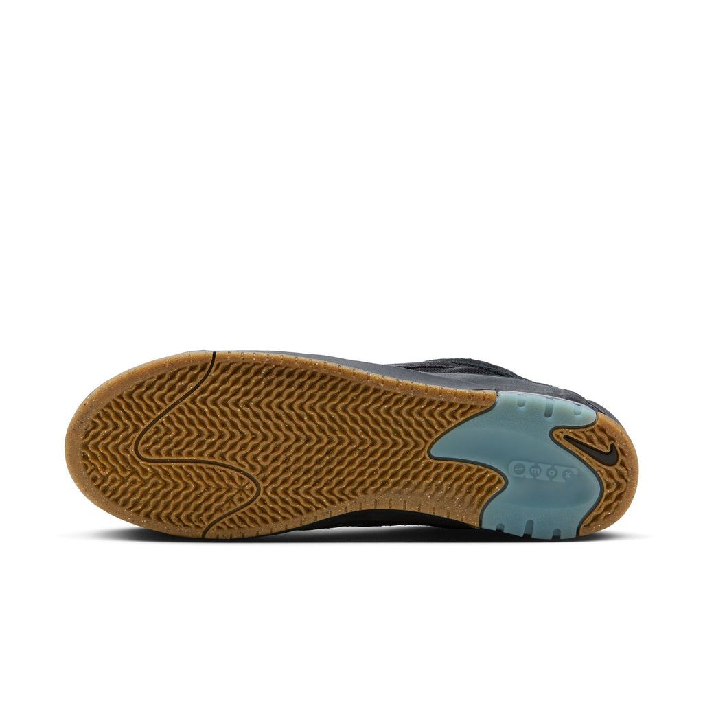 A side view of the sole of a black Nike SB Ishod 2 Air Max sneaker featuring a brown rubber tread pattern and blue accents near the toe area.