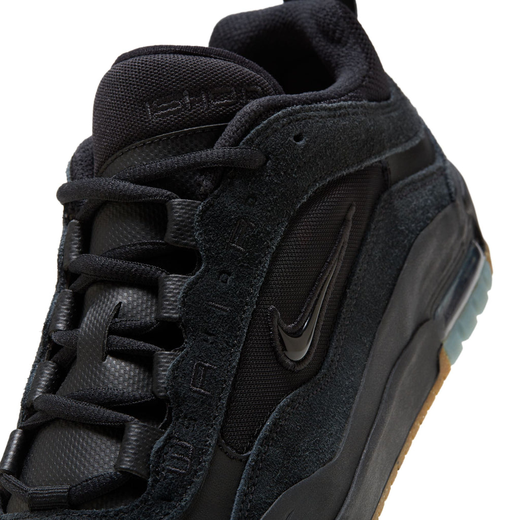 Close-up view of the black nike SB Ishod 2 Air Max skateboarding shoe highlighting the textured fabrics, embroidered nike brand name, and iconic swoosh logo.