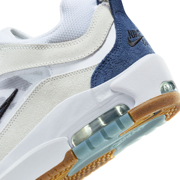 Close-up of a Nike SB Ishod 2 Air Max sneaker featuring the brand's signature swoosh logo, visible air cushioning unit, and a mix of white and varsity red materials.