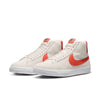 A pair of beige nike SB Blazer Mid Phantom / Cosmic Clay high-top sneakers with red swoosh logos on a white background, ideal for skateboarders.