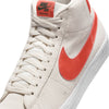 Close-up of a white Nike SB Zoom Blazer Mid sneaker with a red swoosh logo, designed for skateboarders.