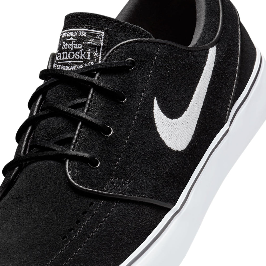 Nike SB Zoom Janoski OG+ shoes, designed specifically for skateboarding, are available in a sleek black and white colorway.