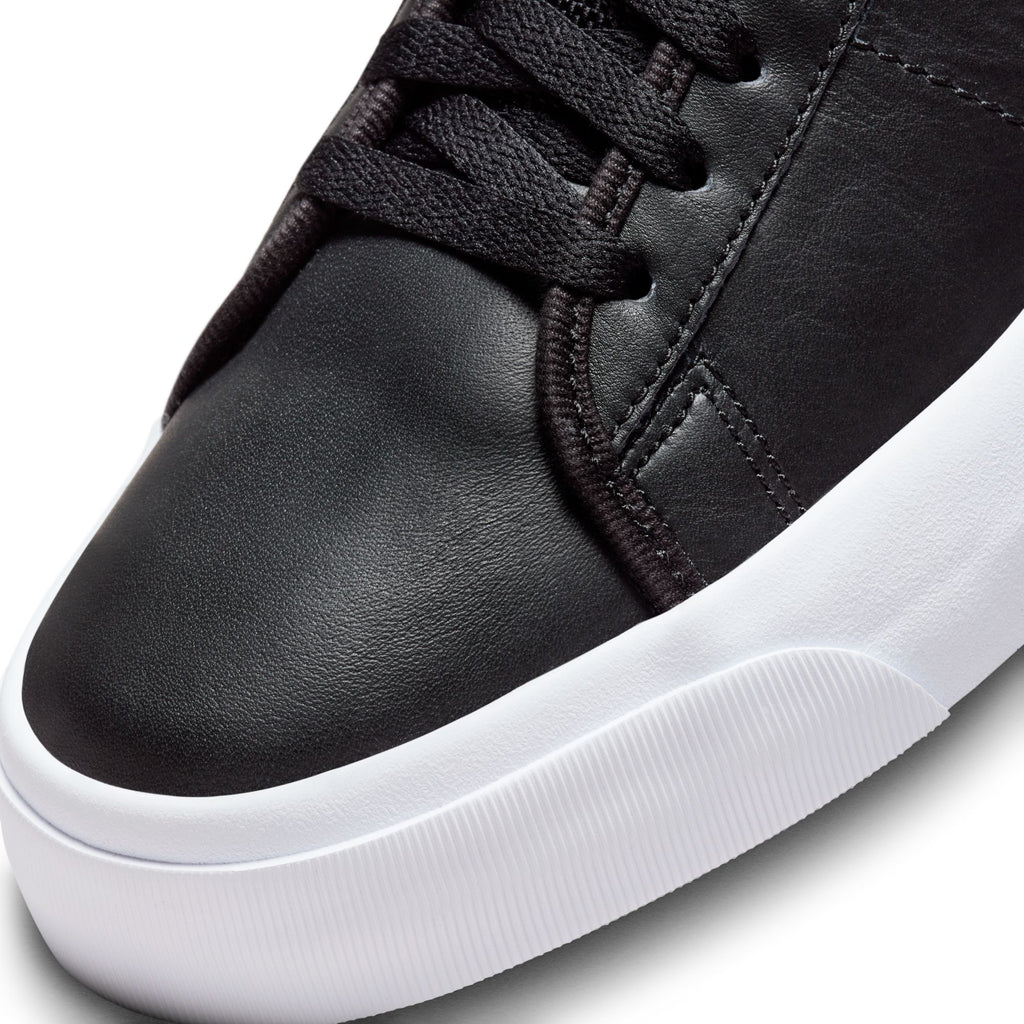 A black Nike SB Blazer Mid Pro GT sneaker with white soles, designed by Grant Taylor for skateboards.