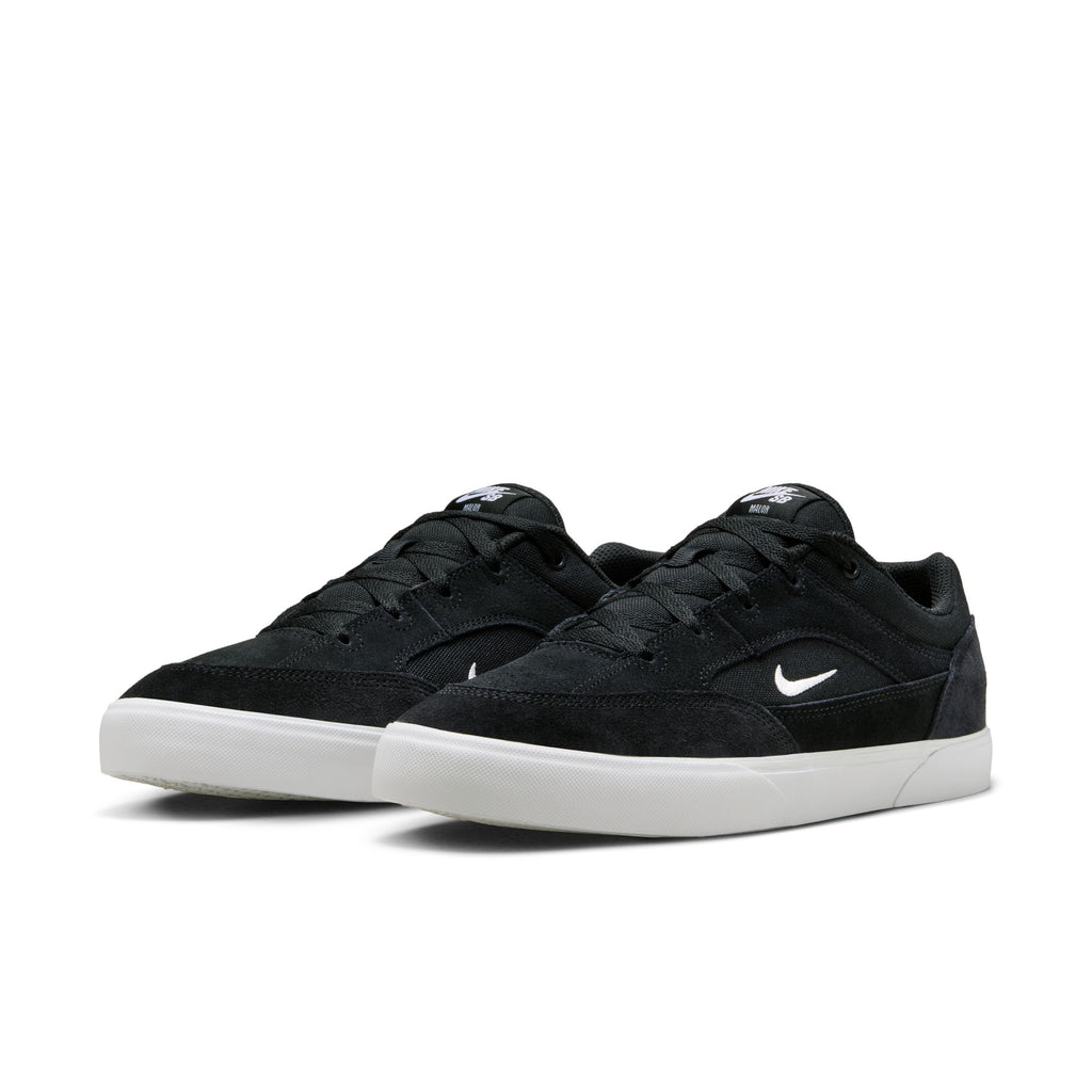 The NIKE SB MALOR BLACK/WHITE skate shoes from Nike feature a black design with white soles and logos, displayed on a white background. These durable sneakers are built to meet the demands of skating.