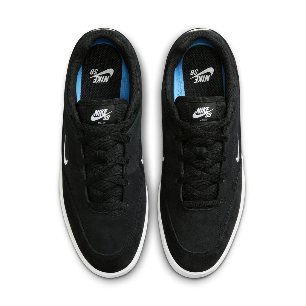 Top view of the NIKE SB MALOR BLACK / WHITE by Nike: durable sneakers showcased with a sleek black design, white swooshes, black laces, and white soles on a plain background.