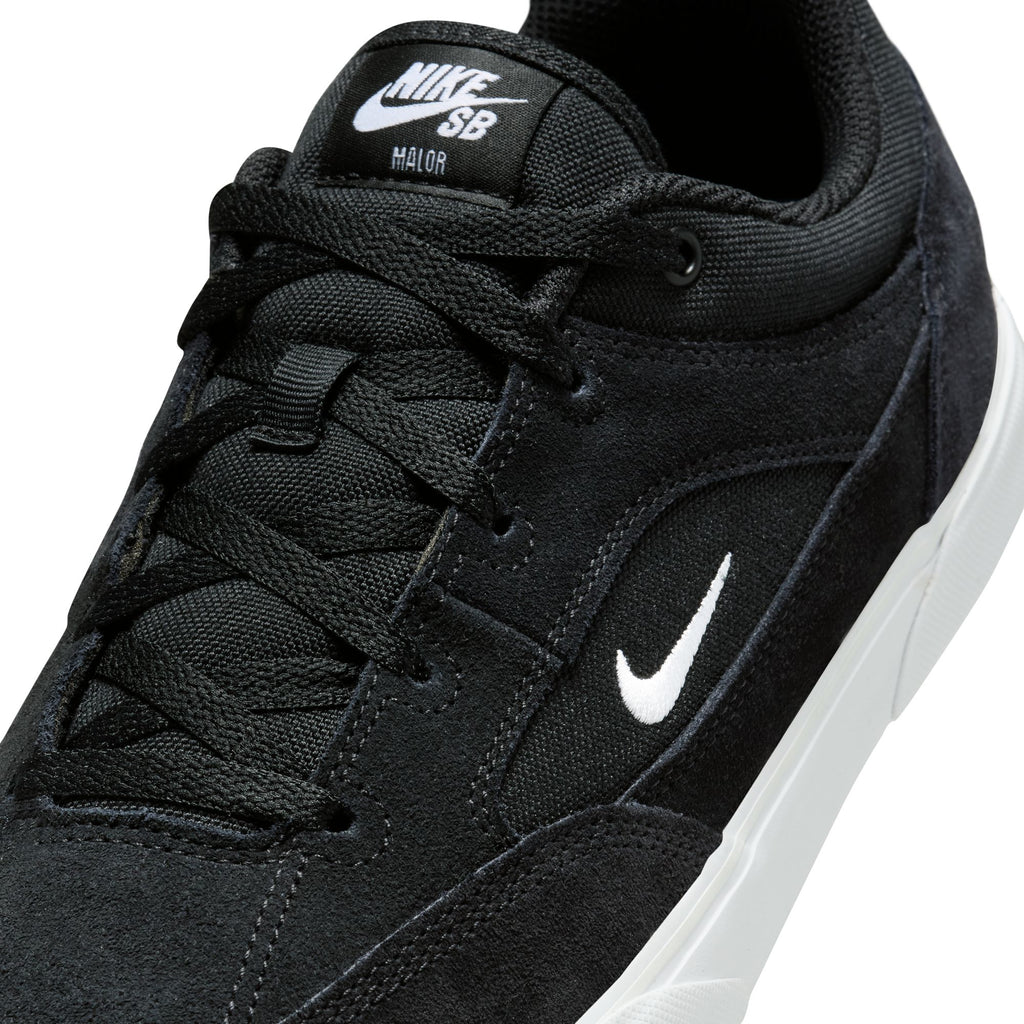 Close-up of the durable NIKE SB MALOR BLACK / WHITE sneaker by Nike, showcasing its black design with a white swoosh logo and white sole.