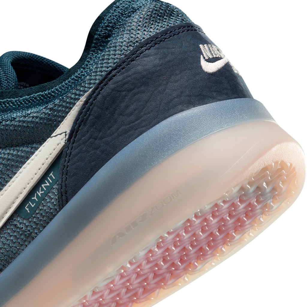 Close-up of a Nike SB PS8 Obsidian/Phantom-Squadron Blue sneaker featuring Flyknit construction, showcasing a textured sole and prominent branding.
