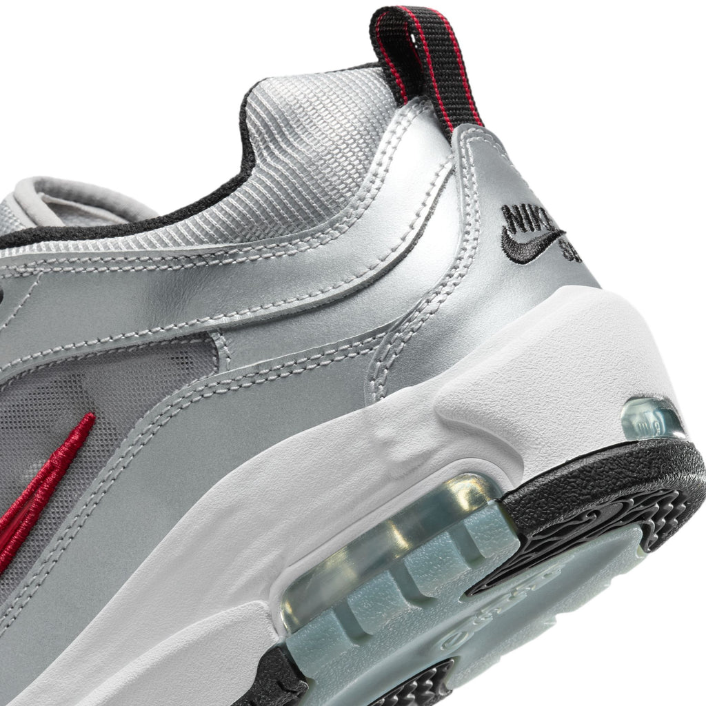 Close-up of the NIKE SB ISHOD 2 AIR MAX in Metallic Silver and Varsity Red, showcasing a transparent air cushion in the heel and a black outsole—blending style with the performance of skate shoes.