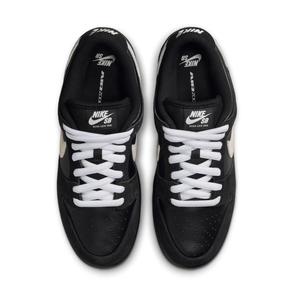 A top view of Nike's SB Dunk Low Pro sneakers in black/white with white laces and iconic swoosh, crafted from premium materials for style and durable traction.