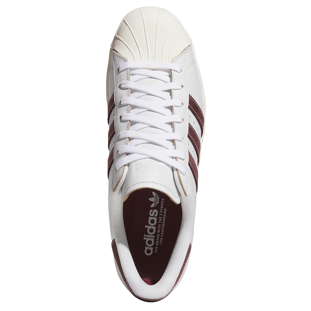 Top view of the ADIDAS SUPERSTAR 80 ADV in Crystal White with Shadow Red stripes and the classic shell toe design.