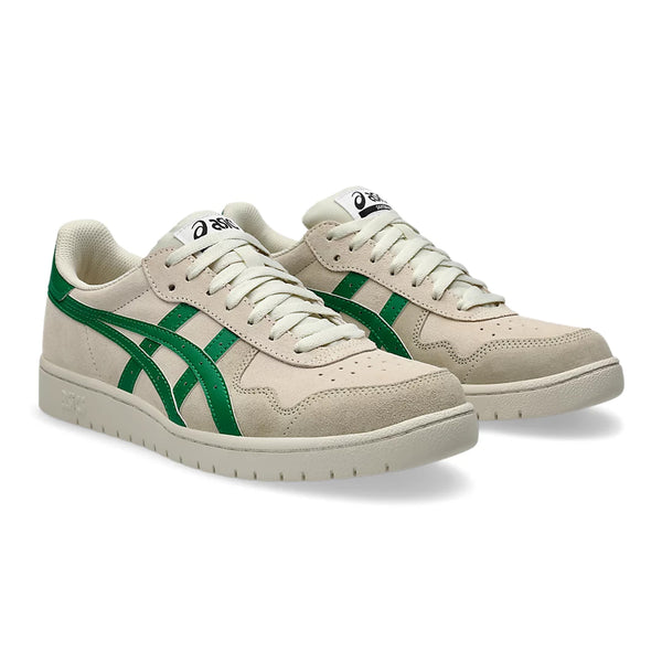 A pair of ASICS skateboarding shoes with green side stripes and white laces, displayed on a white background.
