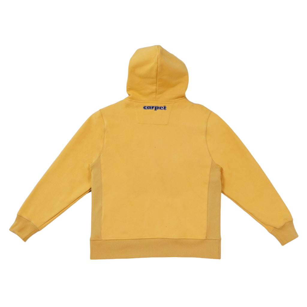 The back of a Carpet Bizarro Zip Hoodie Mustard with a logo on it.
