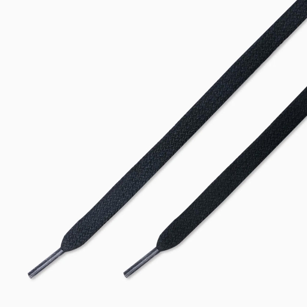 Close-up of black shoelaces with metal aglets, evoking an outdoor-inspired design, from the CONVERSE CONS BOBBY DE KEYZER ONE STAR ACADEMY PRO by CONVERSE.