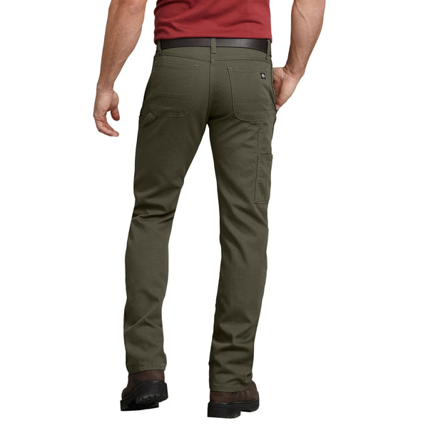 The back view of a man wearing DICKIES REGULAR FIT DUCK CARPENTER PANT MILITARY GREEN pants.