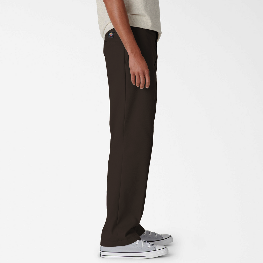 A man wearing DICKIES SKATE TWILL REGULAR FIT PANTS CHOCOLATE BROWN and a white t-shirt.