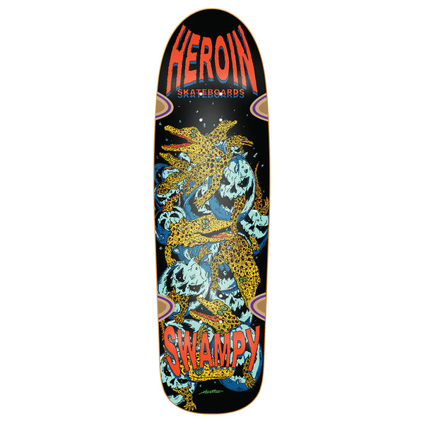 A black skateboard deck with a print of baby alligators climbing out of cracked, evil eggs. 