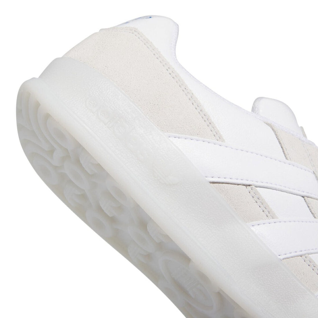 A zoom in of the word 'adidas' on the rubber sole.
