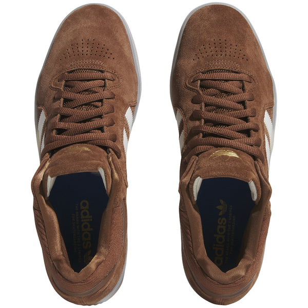 A pair of ADIDAS TYSHAWN PRELOVED BROWN / WHITE shoes with rubber cupsole.