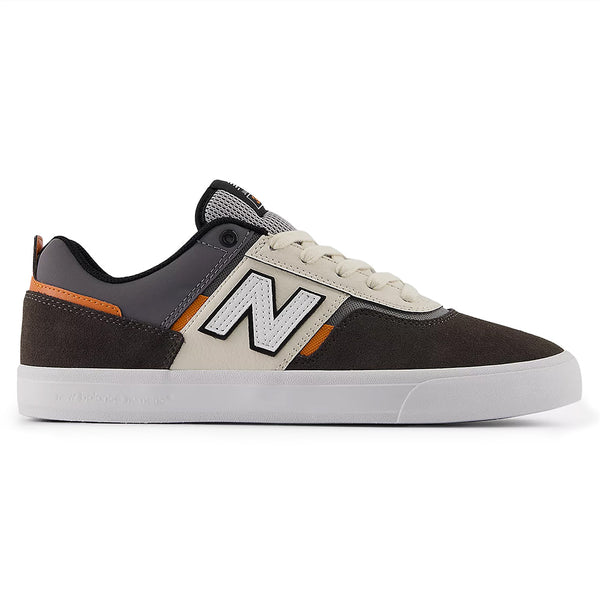 The NB NUMERIC FOY 306 BLACK CEMENT / SEA SALT is a sleek skate shoe in black, gray, cream, and orange with a white "N" logo and rubber sole—designed for style and performance by Jamie Foy.