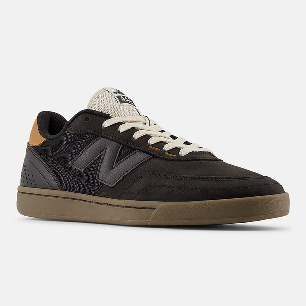 The NB NUMERIC 440 V2 BLACK features a black and brown mesh and leather upper, beige laces, a gum sole, and classic NB Numeric style—ideal for everyday skaters. Shown against a plain white background.