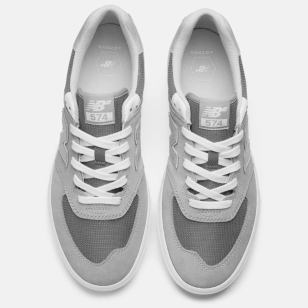 The NB NUMERIC 574 GREY/WHITE sneakers, viewed from above, feature the iconic laces and logo on the tongue, seamlessly transitioning into your skateboarding style with their sleek design.