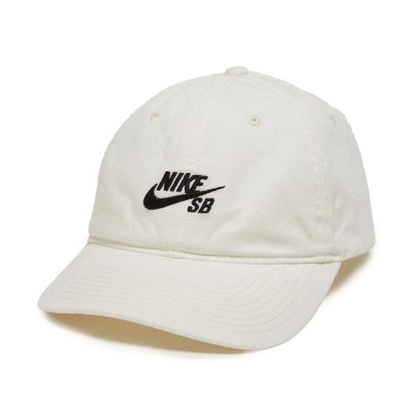 White NIKE SB CLUB HAT SAIL in cotton twill with logo displayed prominently on the front, featuring an adjustable back strap, isolated on a white background.