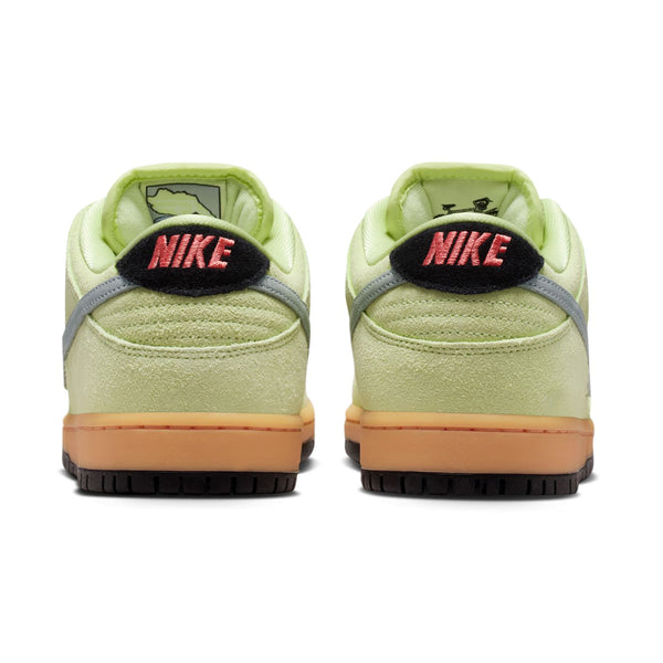 Rear view of the NIKE SB DUNK LOW PRO VERDUGO MOUNTAIN sneakers by nike, featuring light green uppers, gum soles, gray accents, and "NIKE" embroidered in pink on black heel tabs—ideal for adventures near the Verdugo Mountains.