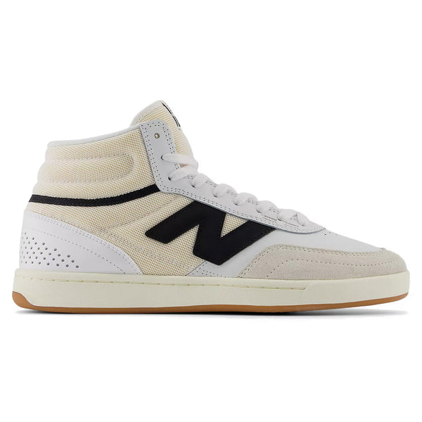 A side view of the NB Numeric 440 high-top skate shoe with a white, beige, and black color scheme. The shoe features a gum sole and a perforated heel area.
---
A side view of the NB NUMERIC NB NUMERIC 440 HIGH V2 WHITE / BLACK high-top skate shoe with a white, beige, and black color scheme. The shoe features a gum sole and a perforated heel area.