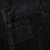 A pair of POLAR '93! DENIM PITCH BLACK pants with a logo on the pocket.