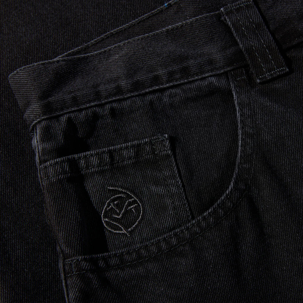 A pair of high waisted, cotton-denim fabric POLAR black jeans with a POLAR logo on the pocket.