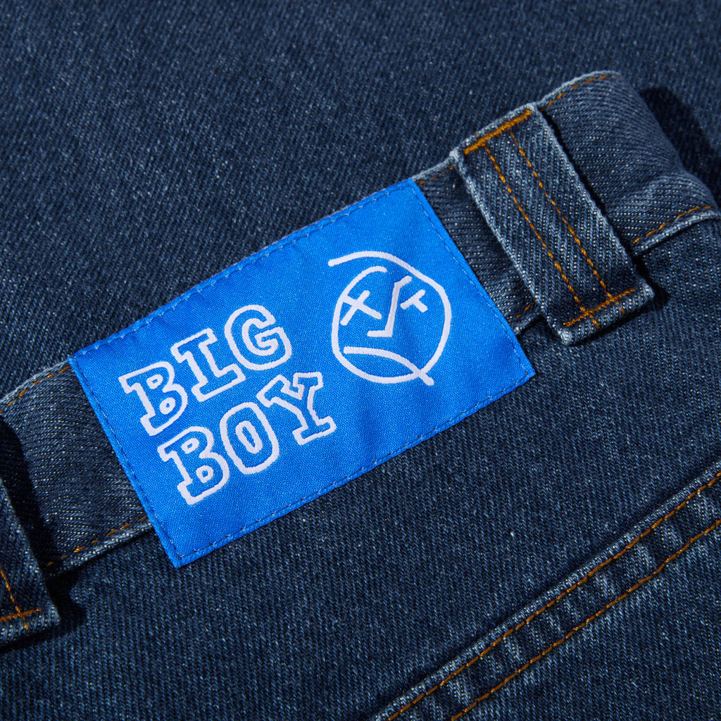 A close up of a POLAR label on a pair of DARK BLUE jeans.