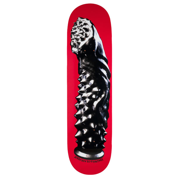 A red skateboard deck with a graphic image of a black studded dildo. 