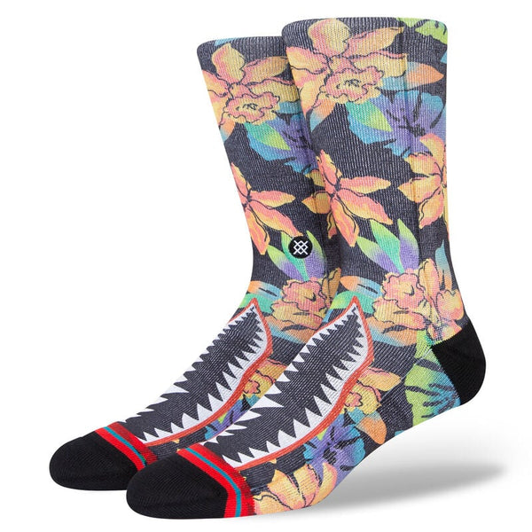 A pair of floral print socks with a shark mouth on the top of the foot.