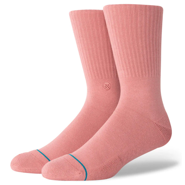 A pair of mauve colored socks with the embroidered stance logo.
