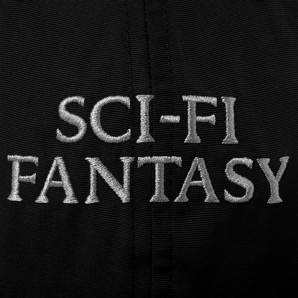 A close up of the silver embroidered sci-fi logo across the front of hte hat.
