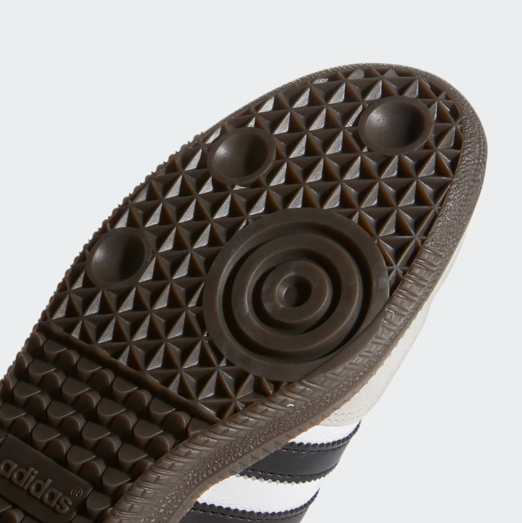 A pair of ADIDAS SAMBA ADV WHITE / BLACK shoes with a black and white sole.