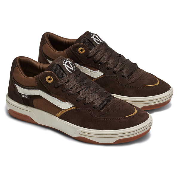 The top view of a pair of brown and white shoes with brown laces and the vans logo on the tongues.