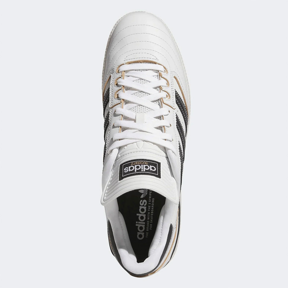 Top view of the ADIDAS BUSENITZ CRYSTAL WHITE / BLACK / OFF WHITE soccer cleat, featuring black stripes, white laces, and a black Adidas logo on the tongue—ideal for soccer or skateboarding enthusiasts.