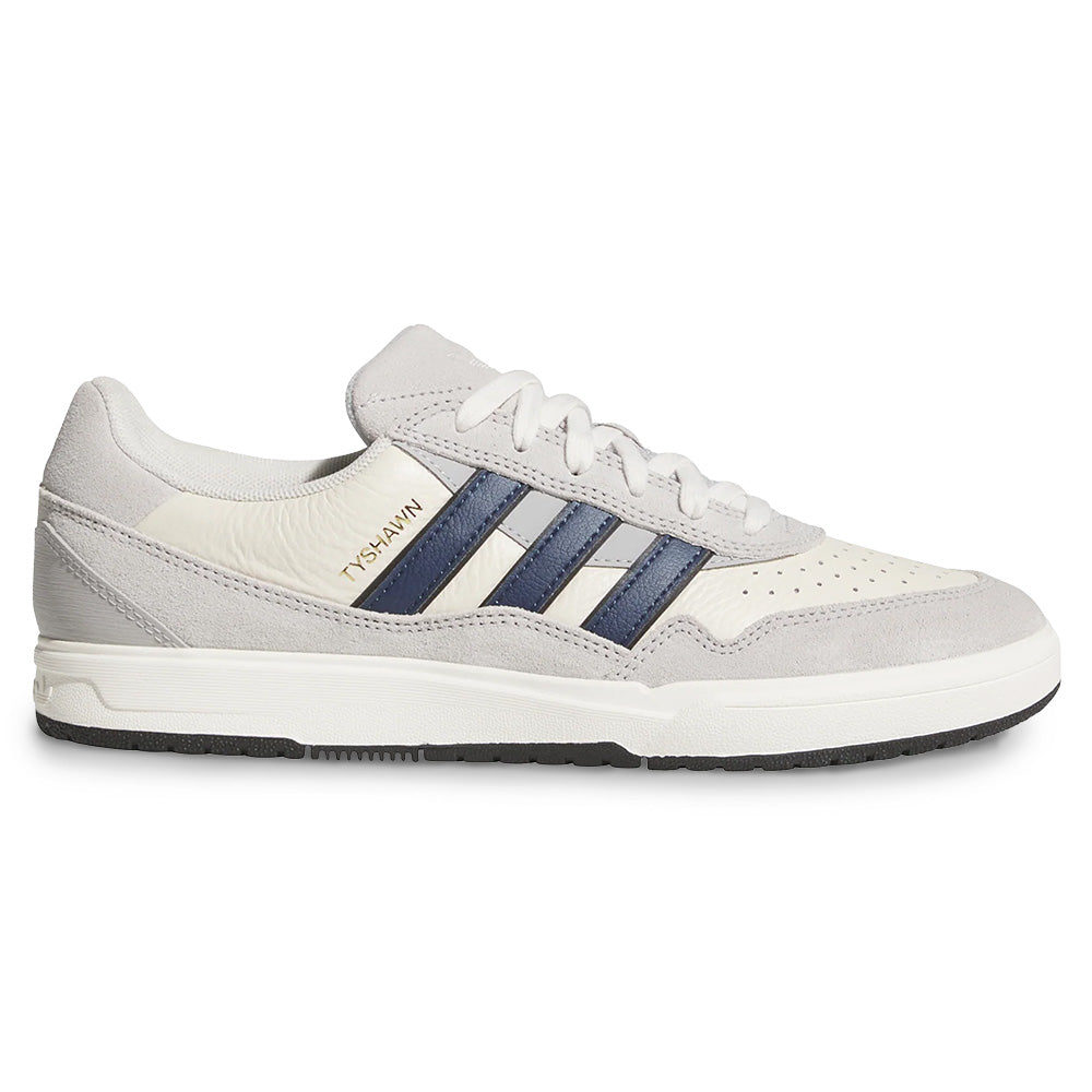The ADIDAS TYSHAWN 2 in Collegiate Navy/Grey is a skateboarding sneaker featuring blue side stripes, "Tyshawn" on the upper, and cupsole construction for enhanced performance.