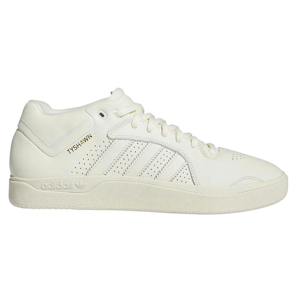 a monochromatic sneaker with Tyshawn's name written in gold metallic letters