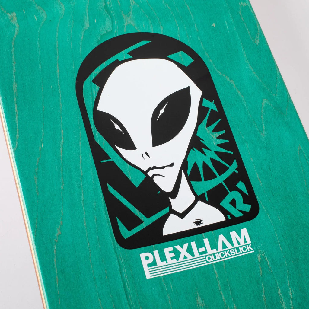 Close-up of an Alien Workshop BELIEVE REALITY PLEXI LAM graphic on a green skateboard deck.